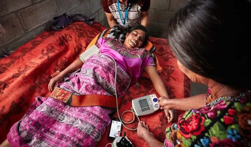 A care navigator accompanies a patient at a health facility.