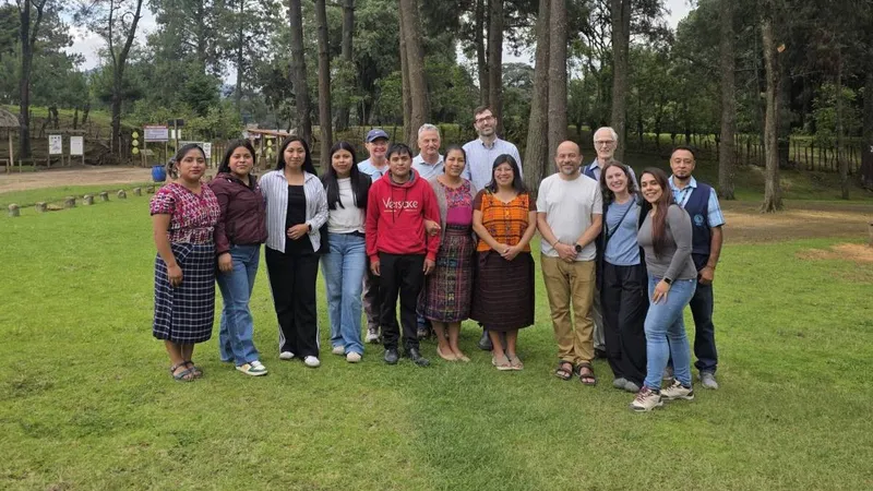 The ELEGUA pilot survey team standing together in a pine forest clearing in Guatemala.