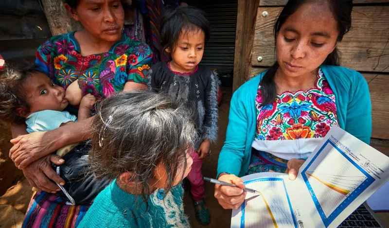 A home visit focused on infant feeding and child development in rural Guatemala.