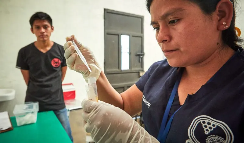 A field team member collects health measurements during a population survey.